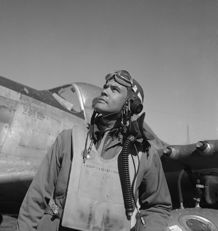 Col. Benjamin O. Davis, half-length portrait, wearing flight gear, standing next to airplane. Reproduction