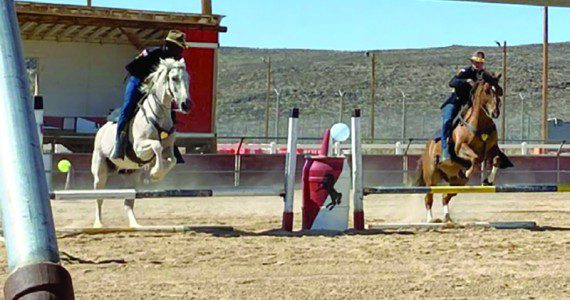 Photo by Staff Sgt. Elizabeth Bryson Troopers from the 11th Armored Cavalry Horse Detachment show precision through synchronized jumping during a demonstration for friends and family June 21, 2022, at the Detachment Barn, Fort Irwin, Calif. The horse detachment carefully selects just the right men and women for the job from within the 11th ACR “Blackhorse” Troopers ranks, and while equestrian experience is not required, character, willingness to learn and the commitment to hard work are essential.