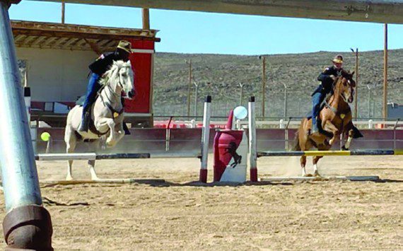 Photo by Staff Sgt. Elizabeth Bryson Troopers from the 11th Armored Cavalry Horse Detachment show precision through synchronized jumping during a demonstration for friends and family June 21, 2022, at the Detachment Barn, Fort Irwin, Calif. The horse detachment carefully selects just the right men and women for the job from within the 11th ACR “Blackhorse” Troopers ranks, and while equestrian experience is not required, character, willingness to learn and the commitment to hard work are essential.