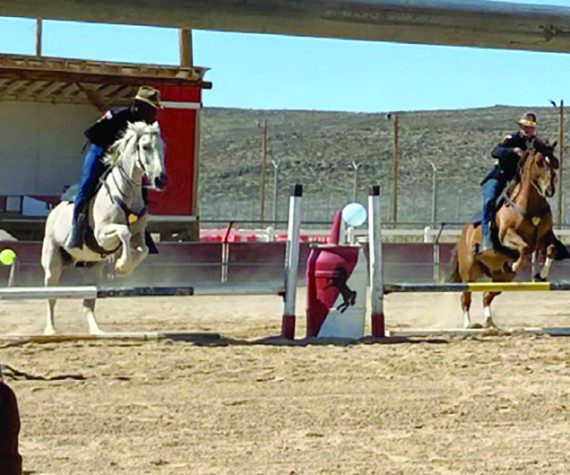 Photo by Staff Sgt. Elizabeth Bryson Troopers from the 11th Armored Cavalry Horse Detachment show precision through synchronized jumping during a demonstration for friends and family June 21, 2022, at the Detachment Barn, Fort Irwin, Calif. The horse detachment carefully selects just the right men and women for the job from within the 11th ACR “Blackhorse” Troopers ranks, and while equestrian experience is not required, character, willingness to learn and the commitment to hard work are essential.