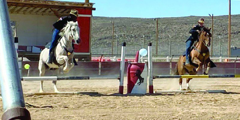 Photo by Staff Sgt. Elizabeth Bryson Troopers from the 11th Armored Cavalry Horse Detachment show precision through synchronized jumping during a demonstration for friends and family June 21, 2022, at the Detachment Barn, Fort Irwin, Calif. The horse detachment carefully selects just the right men and women for the job from within the 11th ACR “Blackhorse” Troopers ranks, and while equestrian experience is not required, character, willingness to learn and the commitment to hard work are essential.