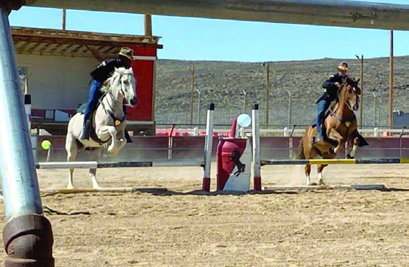 Photo by Staff Sgt. Elizabeth Bryson Troopers from the 11th Armored Cavalry Horse Detachment show precision through synchronized jumping during a demonstration for friends and family June 21, 2022, at the Detachment Barn, Fort Irwin, 
Calif. The horse detachment carefully selects just the right men and women for the job from within the 11th ACR “Blackhorse” Troopers ranks, and while equestrian experience is not required, character, willingness to learn and the commitment to hard work are essential.