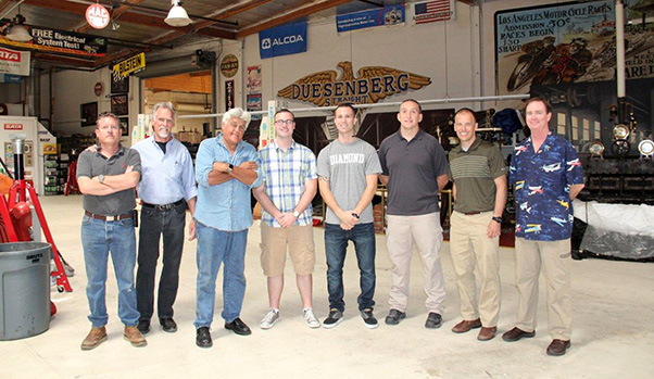 Photograph by Linda KC Reynolds Bigger than life -- Members of Edwards Air Force Base Operations Support Squadron were invited by F-22 Honorary Commander, Art Thompson of A2ZFX and Sage Cheshire, for a personal tour of Jay Leno’s Garage and Emory Motorsports in Burbank, Calif. SSgt. Tyler Stuart, was recently awarded the 2015 Air Force Airfield Management Journeyman of the Year for managing 22 runways over three airfields and two dry lakebeds. From left: John Pera, Art Thompson, Jay Leno, SSgt Tyler Stuart, Airmen Andrew Miller, Lt. Col Mark Massaro, Commander 412 OSS and David Sampson, Airfield Manager.
