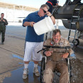 Lockheed Martin photograph by Chad Bellay Lockheed Martin aerial photographer, Tom Reynolds gets a cool wash down from neighbor Jim Tholen as Test Pilot Maj. Sean Richardson watches on, during Reynolds’ fini-flight celebration. For more than 30 years Reynolds covered testing of the YF-22, F-22, X-35 and F-35. He has more than 1,800 hours in the F-16 and hundreds more in the F-15.