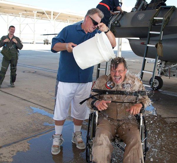 Lockheed Martin photograph by Chad Bellay Lockheed Martin aerial photographer, Tom Reynolds gets a cool wash down from neighbor Jim Tholen as Test Pilot Maj. Sean Richardson watches on, during Reynolds’ fini-flight celebration. For more than 30 years Reynolds covered testing of the YF-22, F-22, X-35 and F-35. He has more than 1,800 hours in the F-16 and hundreds more in the F-15.