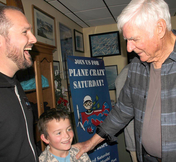 Photograph by Linda KC Reynolds Bryan Ford and his son flew from San Luis Obispo to hear some of the adventures of the Voyager and chat afterwards with Dick Rutan during the 30th anniversary celebration of the Voyager. The flight around the world took off from Edwards Air Force Base Dec. 14, 1986 and lasted nine days, three minutes and 44 seconds. Tens of thousands drove out to wait on Rogers Dry Lakebed to welcome them home.