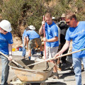 Photograph by Linda KC Reynolds Getting it done — Lockheed Martin employees mix cement and pour sidewalks to help veterans build 78 homes in Santa Clarita with Habitat for Humanity.