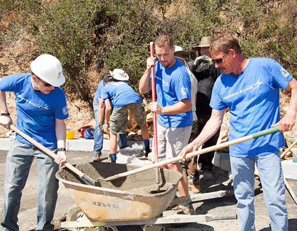 Photograph by Linda KC Reynolds Getting it done — Lockheed Martin employees mix cement and pour sidewalks to help veterans build 78 homes in Santa Clarita with Habitat for Humanity.