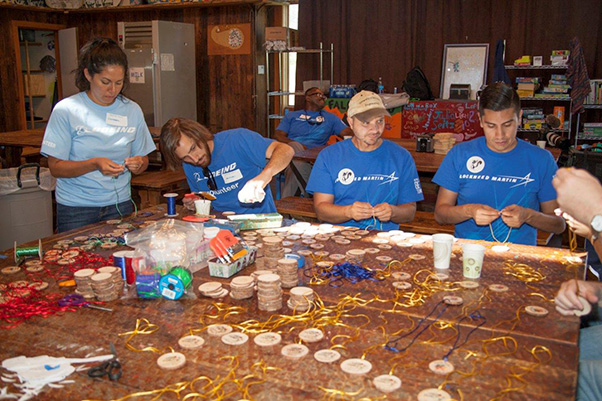 Photograph by Linda KC Reynolds Several hundred badges were made by aerospace workers for kids who will be attending the Painted Turtle Camp. Volunteering a few hours saves the camp staff hundreds of labor hours and is a very rewarding experience for all who volunteer.