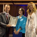 Photo by Linda KC Reynolds Board of Directors for the Flight Test Historical Foundation, Chairwoman Lisa Gray (right) presents Lisa Brown the Volunteer of the Year award for her outstanding contributions in the development of the curriculum for the online Junior Test Pilot School and on-site, eight week summer program at the Blackbird Airpark in Palmdale Calif., where children learned the fundamentals of flight with hands-on experiments. Guest teachers included test pilots and engineers. 