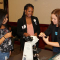 Photograph by Linda KC Reynolds Getting cheeky: Jazmin Sanchez from Highland High School and Mera Burton from Aero Institute hand their cheek cells to Antelope Valley College student Sarah Schroeder during The Antelope Valley East Kern STEM Network 5th annual STEMposium “The Future of Innovation.” The event helps school and industry leaders network to promote STEM education and learn what industries need from future employees.