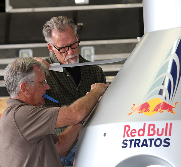 Photographs by Linda KC Reynolds Ready to launch — Art Thompson of A2zFX and Sage Cheshire works with Kent Burns placing final decals on a Red Bull Stratos capsule that will be shipped to the Sheikh Jaber Al Ahmad Cultural Centre in Kuwait. Thompson designed the original capsule and a flight suit for Red Bull where Felix Baumgartner broke the speed of sound reaching an estimated speed of 833.9 mph jumping from the stratosphere Oct. 14, 2012.