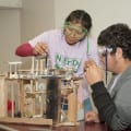 Photograph by Linda KC Reynolds Nelly Torres and Adrian Valenzuela from Francisco Bravo Medical Magnet High School in East LA participate in “Mission Possible and set up their Rube Goldberg experiment during the 32nd Annual Los Angeles County Science Olympiad at the Antelope Valley College.