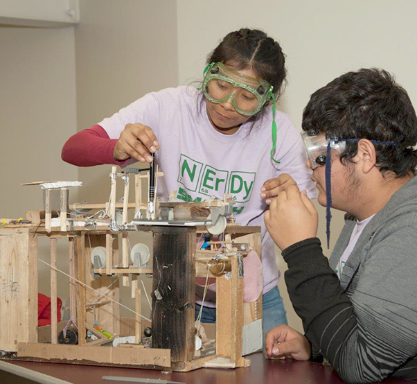 Photograph by Linda KC Reynolds Nelly Torres and Adrian Valenzuela from Francisco Bravo Medical Magnet High School in East LA participate in “Mission Possible and set up their Rube Goldberg experiment during the 32nd Annual Los Angeles County Science Olympiad at the Antelope Valley College.