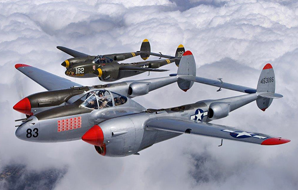 Photograph by Michael D. Jackson Two P-38s flying echelon formation as part of a planned photo flight from the LA County Air Show to Chino, Calif.
