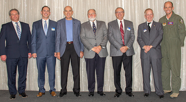 Photograph by Linda KC Reynolds Bill McCabe, David Norris Chris Spicher, Les Uhazy, George Nagy and Bob Slade were sworn in by Brig Gen E. John “Dragon” Teichert, as Incoming Class of 2021 Directors during the Annual Installation of Officers and Directors at the Edwards AFB Civilian-Military banquet.