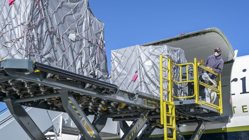 A NASA Armstrong Flight Research Center crewmember offloads supplies from a DC-8 for an Emergency Field Hospital at Air Force Plant 42 in Palmdale, California, Jan. 11. Samaritan’s Purse, charitable organization, has partnered with Lancaster Baptist Church, the city of Lancaster and AV Hospital to provide a 70-bed temporary field hospital to support COVID-19 patients. (Air Force photo by Giancarlo Casem)