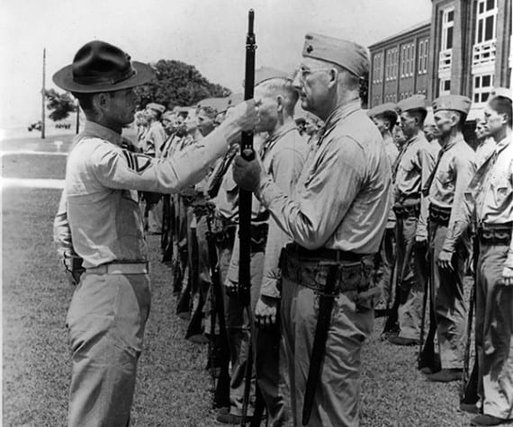 Pvt. Paul Douglas, age 50, preforms a rifle inspection with his drill instructor aboard Marine