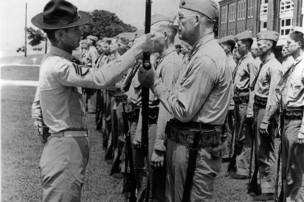Pvt. Paul Douglas, age 50, preforms a rifle inspection with his drill instructor aboard Marine