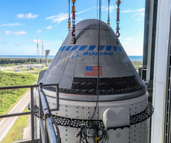 The Boeing CST-100 Starliner spacecraft is secured atop a United Launch Alliance Atlas V rocket at the Vertical Integration Facility at Space Launch Complex 41 at Cape Canaveral Space Force Station in Florida. (Boeing photograph by John Grant)