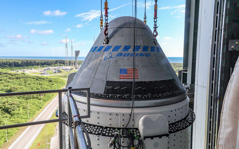 The Boeing CST-100 Starliner spacecraft is secured atop a United Launch Alliance Atlas V rocket at the Vertical Integration Facility at Space Launch Complex 41 at Cape Canaveral Space Force Station in Florida. (Boeing photograph by John Grant)