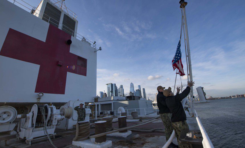 Sailors participate in a morning colors ceremony aboard the hospital ship USNS Comfort (T-AH 20) while the ship is moored in New York City in support of the nation’s COVID-19 response efforts. Comfort will serve as a referral hospital for non-COVID-19 patients currently admitted to shore-based hospitals. This allows shore-based hospitals to focus their efforts on COVID-19 cases. One of the Department of Defense's missions is Defense Support of Civil Authorities. DoD is supporting the Federal Emergency Management Agency, the lead federal agency, as well as state, local and public health authorities in helping protect the health and safety of the American people. (U.S. Navy photo by Mass Communication Specialist 2nd Class Sara Eshleman)