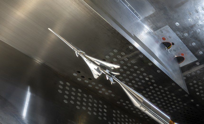 The X-59 small-scale model is seen in NASA Glenn’s 8- by- 6-foot Supersonic Wind Tunnel. The model was inverted with the shock wave sensor array mounted on the tunnel’s ceiling during the testing. (NASA photograph)