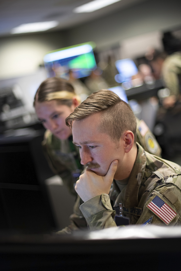 U.S. Space Force Sgt. Cassidy Basney (left) and Specialist 4 Neale Hart (right) provide intelligence assessments to drive simulated combat operations during Space Flag 22-3 at Schriever Space Force Base, Colo., Aug. 16, 2022. Considered a tactically-focused exercise, Space Flag is designed to provide tactical space units with advanced training in a simulated contested, degraded and operationally-limited environment. The exercise is conducted using live, virtual and constructive simulations which immerse Guardians and participants into a synthetic virtual battlefield.