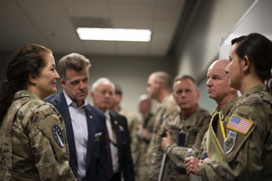 U.S. Space Force Capt. Rachel Alessi (right), Space Flag 22-3 tactical assistant, brief Space Flag distinguished visitors on her role guiding exercise players through the mission planning and execution process at Schriever Space Force Base, Colo., Aug. 16, 2022. Considered a tactically-focused exercise, Space Flag is designed to provide tactical space units with advanced training in a simulated contested, degraded and operationally-limited environment. The exercise is conducted using live, virtual and constructive simulations which immerse Guardians and participants into a synthetic virtual battlefield.
