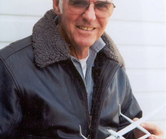 Dick Rutan holds a model of the Voyager aircraft. (Courtesy photograph)
