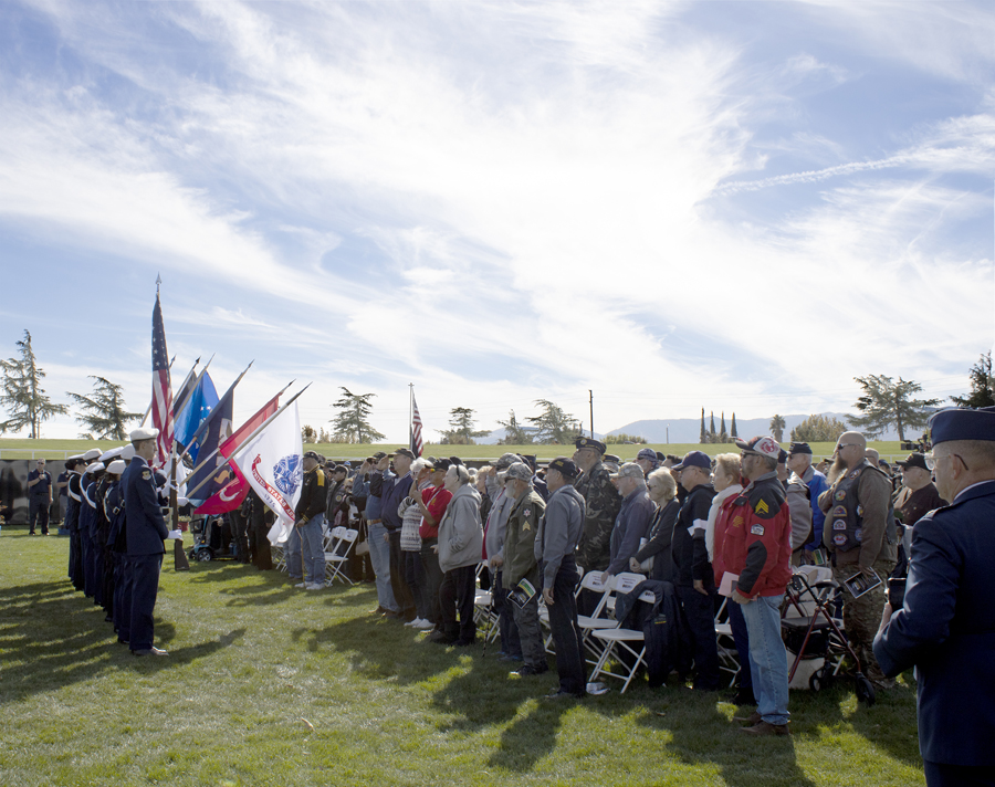 Under the direction of Cadet 1st Lt. Kathlina Cortez, the Highland High Air Force Junior ROTC CA-99, Littlerock High Army Junior ROTC and Antelope Valley High Navy Junior ROTC present the colors during the Pledge of Allegiance and the National Anthem at the AV Wall Veterans Day Ceremony, Nov. 11, 2022. (Photograph by Adrienne King)