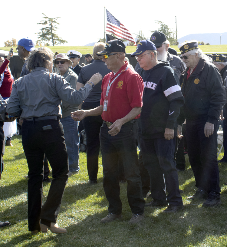 First Vice Commander of American Legion Post #348 Carl Hernandez receives a Vietnam Veteran from Stacia Nemeth during the Vietnam Veteran Pin Distribution at the AV Wall Veterans Day Ceremony, Nov. 11, 2022. (Photograph by Adrienne King)