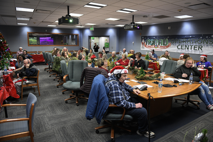 Nearly 1,000 volunteers cycled through the NORAD Tracks Santa Operations Center on Peterson Space Force Base, Colorado, between 4 a.m. and 10 p.m. Dec. 24, 2022. Volunteers providing updated information on Santa's location and gifts delivered worked in two-hour shifts answering phone calls from children and adults located around the globe. (Department of Defense photo by Chuck Marsh)