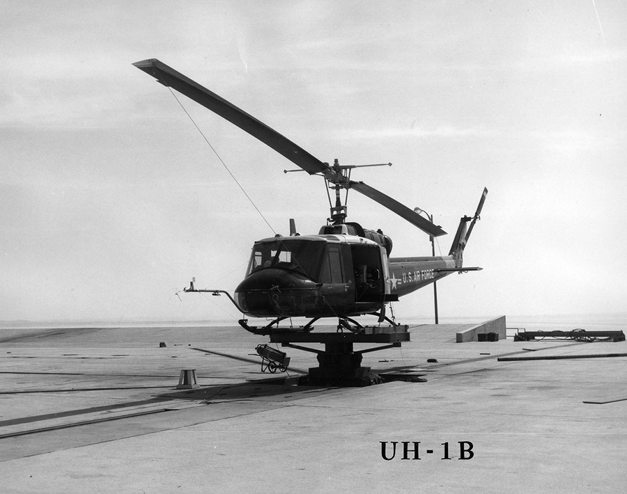 A black and white image of a UH-1B Huey