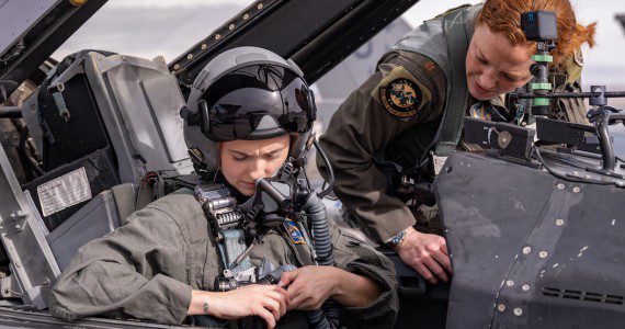 U.S. Air Force 2nd Lt. Madison Marsh buckles in for her familiarization flight at Nellis Air Force Base, Nev., Dec. 19, 2023. Marsh is a 2023 U.S. Air Force Academy graduate, and she won the title of Miss America Jan. 14, 2024, making her the first active-duty Air Force officer to win the Miss America pageant. (U.S. Air Force photo by William R. Lewis)