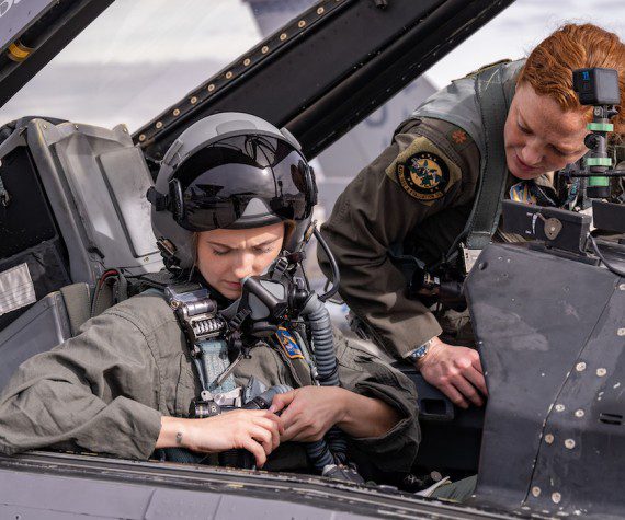 U.S. Air Force 2nd Lt. Madison Marsh buckles in for her familiarization flight at Nellis Air Force Base, Nev., Dec. 19, 2023. Marsh is a 2023 U.S. Air Force Academy graduate, and she won the title of Miss America Jan. 14, 2024, making her the first active-duty Air Force officer to win the Miss America pageant. (U.S. Air Force photo by William R. Lewis)