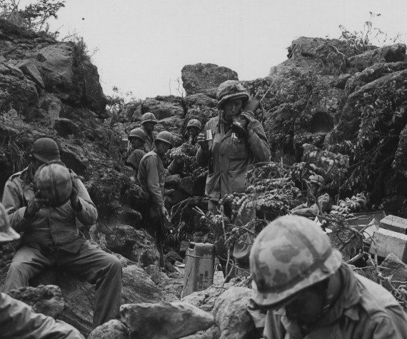 Marines of the 28th Marines, 5th Marine Division, gather at the forward command post on Iwo Jima in 1945. (Photo By: Army/National Archives)