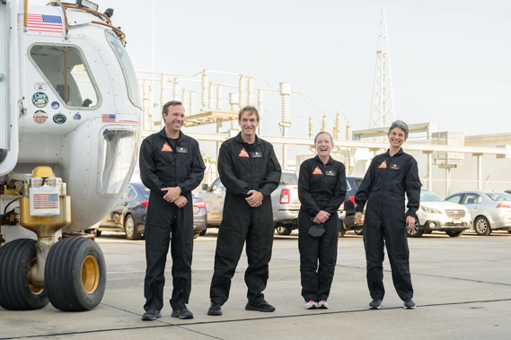 The CHAPEA Mission 1 crew (from left: Nathan Jones, Ross Brockwell, Kelly Haston, Anca Selariu) exit a prototype of a pressurized rover and make their way to the CHAPEA facility ahead of their entry into the habitat on June 25, 2023. (Credit: NASA/Josh Valcarcel)