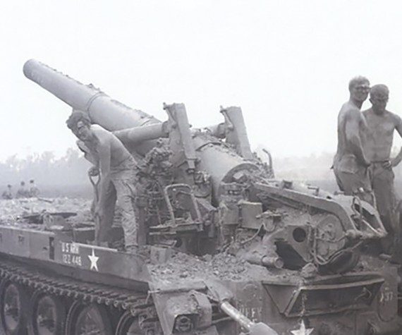 Army soldiers survey their 8-inch mobile howitzer for damage caused by a rocket-propelled grenade at Fire Support Base Illingworth in Vietnam, April 1, 1970. (Photo by Christopher Wilson, Army)