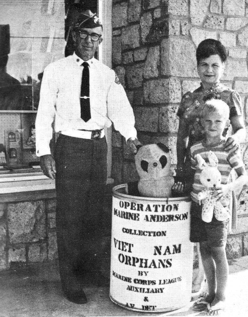 United States Marine Corps Pfc. John Anderson’s mother poses with a collection barrel in front of Helen’s Toy Shop on Lancaster Boulevard. Mrs. Anderson’s Marine Corps Auxiliary started “Operation Marine Anderson” to gather toys and clothing for Vietnamese orphans. (Courtesy photograph)
