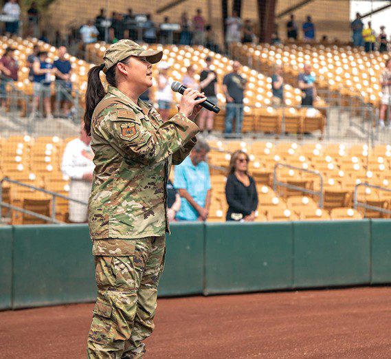 U.S. Air Force Master Sgt. Michelle Gagnon, 607th Air Control Squadron plans and programs flight chief, sings the National Anthem during the 2025 Military Appreciation game, Mar. 23, 2025 at the Camelback Ranch baseball complex, Glendale, Arizona.