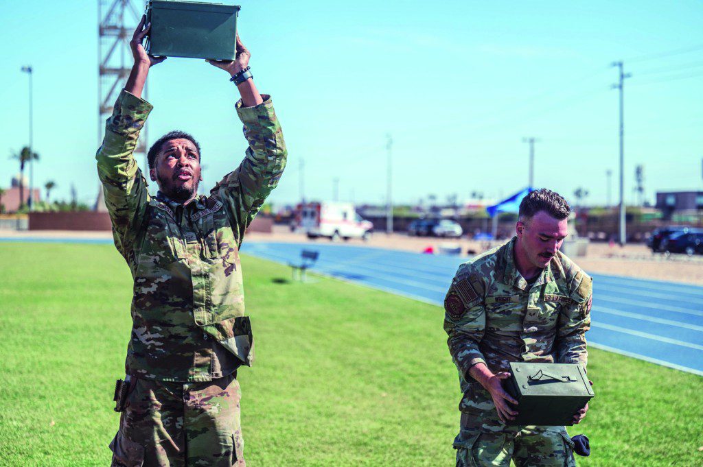 U.S. Air Force Airman 1st Class Jren Jordan (left), and Senior Airman Jason Wright (right), 56th Security Forces Squadron defenders, conduct ammo can presses during the 2025 Police Week Defender Challenge, May 13, 2025, at Luke Air Force Base, Arizona. The Defender Challenge consists of various strength and endurance trials, including tire flips, casualty movements, and ammo can presses. The Defender Challenge is part of National Police Week, which honors the men and women of law enforcement agencies around the country, while remembering those who gave their lives in service.