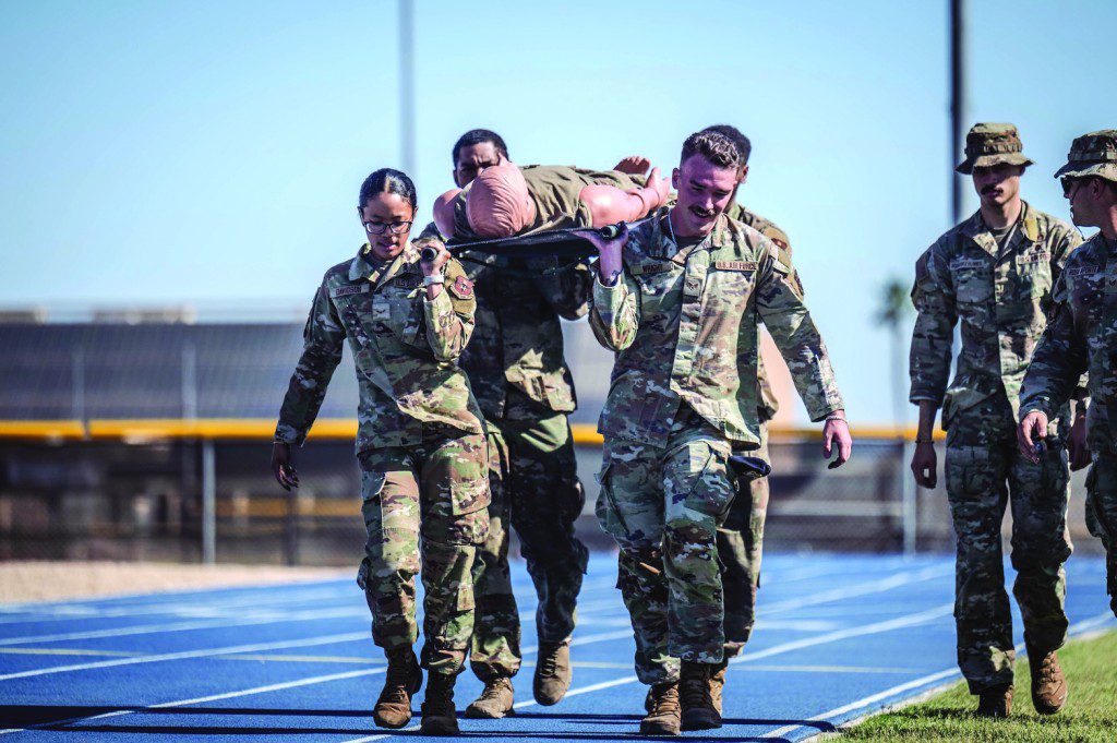 U.S. Air Force Airmen assigned to the 56th Security Forces Squadron move a simulated casualty during the 2025 Police Week Defender Challenge, May 13, 2025, at Luke Air Force Base, Arizona. The Defender Challenge consists of various strength and endurance trials, and is part of National Police Week, which honors the men and women of law enforcement agencies around the country, while remembering those who gave their lives in service.