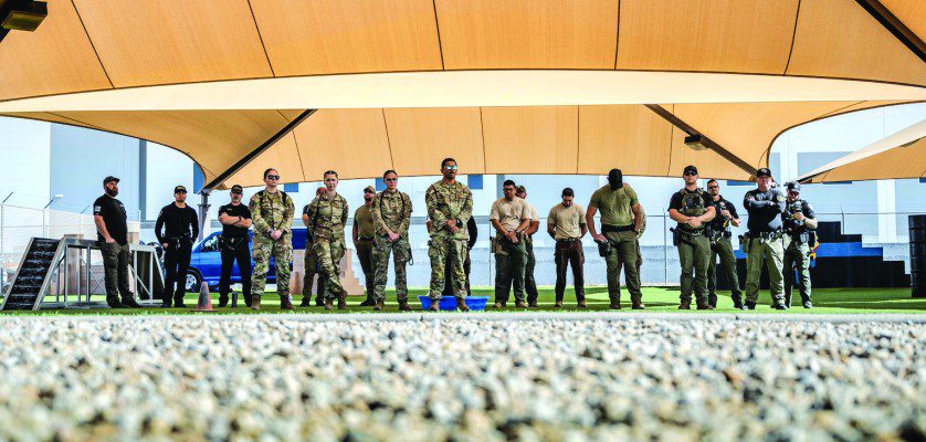 U.S. Air Force Airmen assigned to the 56th Fighter Wing and civilian law enforcement officers await the start of a K-9 competition, May 14, 2025, at Luke Air Force Base, Arizona. The 56th FW held various events throughout Police Week to commemorate fallen defenders and honor current security forces and civilian officers. These individuals keep the base and community safe every day of the week.