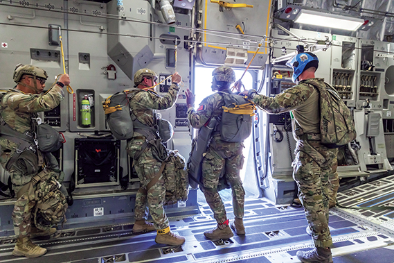 Tech. Sgt. Robert Gregory, 412th OSS SERE/TPP superintendent, prepares Army Civil Affairs troopers for a static line jump aboard a C-17 above Edwards Air Force Base, Calif., April 11, 2025. (Air Force photograph by James West)