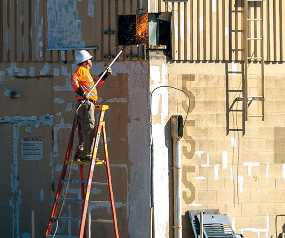 Workers cut the exterior of the former air traffic control tower before demolition at USAF Plant 42 in Palmdale, California, April 29, 2025. Removing excess infrastructure is a critical milestone in reducing waste and improving airfield safety. The tower, originally opened in 1958, was recently replaced by a modern and taller tower that allows safer operations at the production flight test facility. (U.S. Air Force photo by Jennifer Healy)