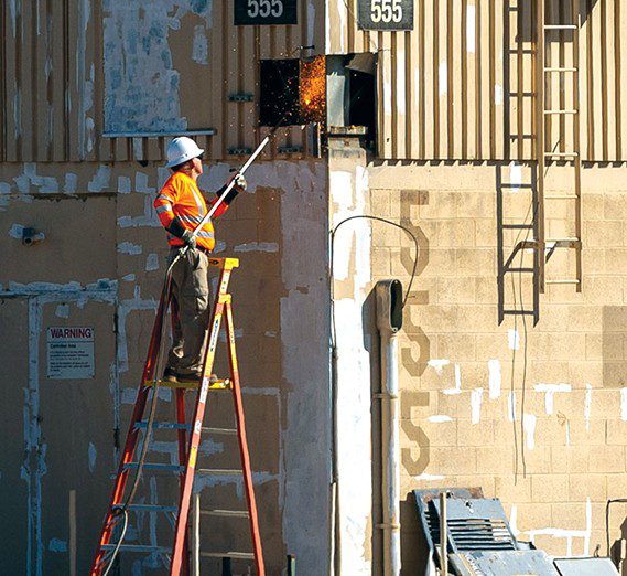 Workers cut the exterior of the former air traffic control tower before demolition at USAF Plant 42 in Palmdale, California, April 29, 2025. Removing excess infrastructure is a critical milestone in reducing waste and improving airfield safety. The tower, originally opened in 1958, was recently replaced by a modern and taller tower that allows safer operations at the production flight test facility. (U.S. Air Force photo by Jennifer Healy)