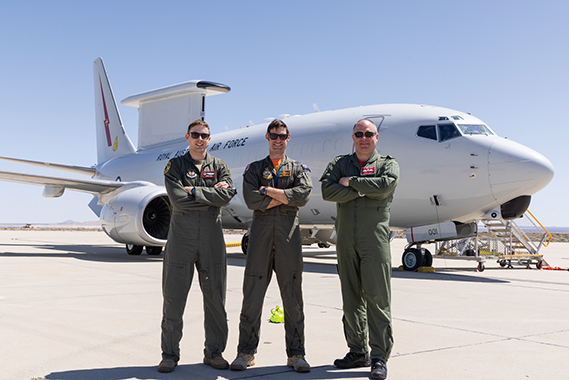 Maj. Jeremy Rohn, 418th Flight Test Squadron, Sqnldr. Owen Hamilton, Royal Australian Air Force and Squadron Leader Angus Lilly, Royal Air Force, pose in front of a E-7A Wedgetail aircraft at Edwards Air Force Base, CA. The trilateral testing with a USAF KC-46A allows for enhanced combat capability, while allowing early experience for the USAF and RAF as future E-7 variant operators. (Air Force photo by Daniel Kelley)