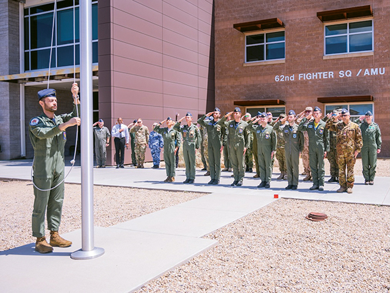 Defense attachés from allied and partner nations and Italian F-35A Lightning II pilots attend an Italian flag raising ceremony during a base visit, June 2, 2025, at Luke Air Force Base, Arizona. June 2 is Italy’s Republic Day, commemorating the 1946 referendum in which Italians voted to transition from a monarchy to a republic. The group of attachés attended a flag-raising ceremony in honor of the holiday as a show of respect and solidarity with their Italian counterparts, reinforcing the importance of alliance and mutual recognition among partner nations. (U.S. Air Force photo by Senior Airman Elias Carrero)