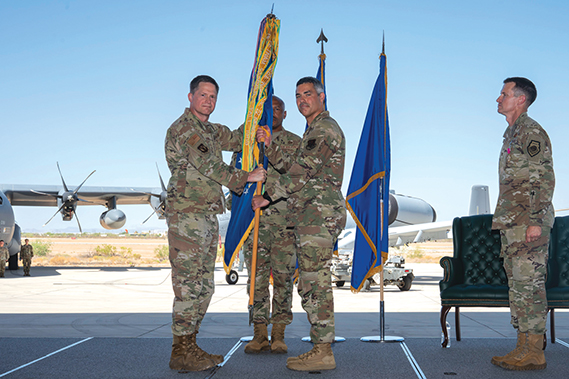 Maj. General David Lyons, 15th Air Force commander, presents the guidon to Col. Jose Cabrera, incoming 355th Wing commander, during the 355th Wing Change of Command ceremony at Davis-Monthan Air Force Base, Ariz., July 10, 2025. In this role, Cabrera will oversee the readiness, welfare and integration of more than 11,000 personnel across the installation. (Air Force photograph by Airman Samantha Melecio)